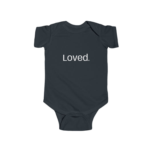 Woman and child wearing black shirts with 'Love.' and 'Loved.' text on a white background