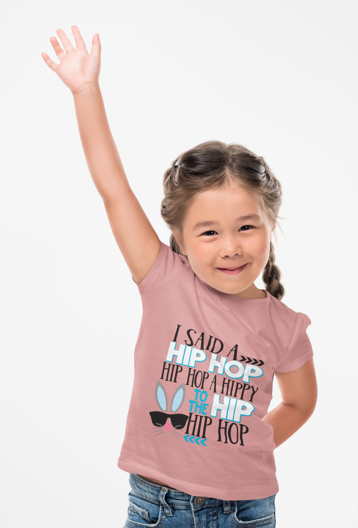 Child wearing a pink t-shirt with text and graphics, raising one arm.