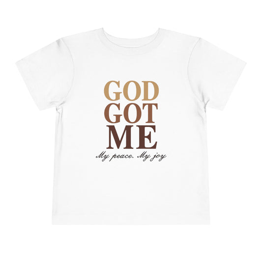 Beige t-shirt with 'God Got Me' text design on a white background
