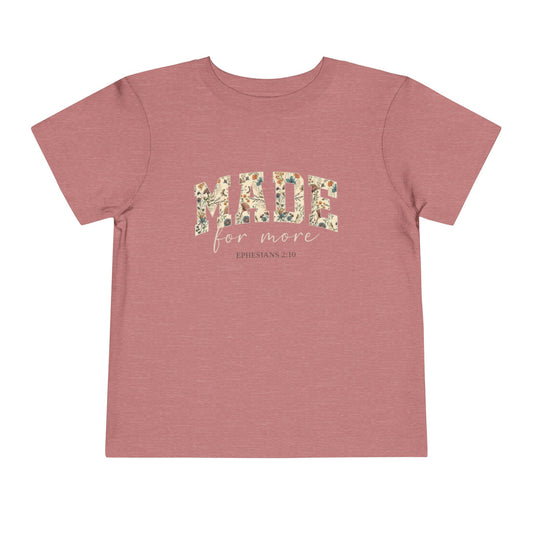 Pink t-shirt with floral text design 'made for more' with text Ephesians 2:10