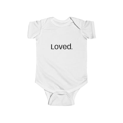 White baby onesie with 'Loved' text on a white background