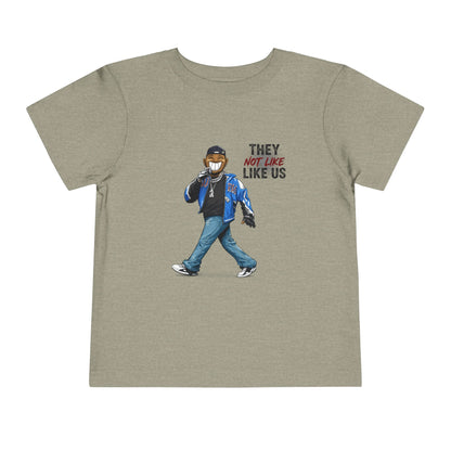 T-shirt with graphic of a person wearing a mask and text 'THEY NOT LIKE US' on a beige background