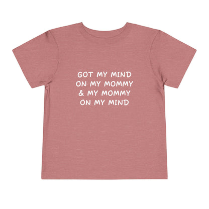 Pink t-shirt with white text on a white background