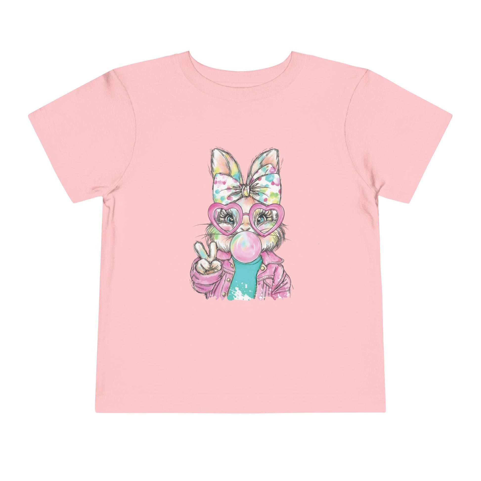Pink t-shirt with a cartoon character wearing glasses and a bow on a white background