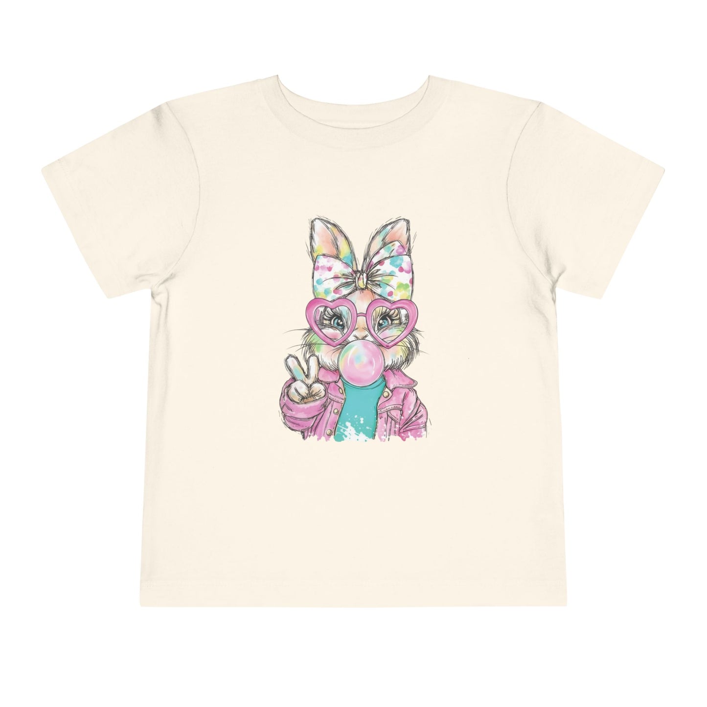 Beige t-shirt with a colorful cartoon bunny holding a peace sign on a white background