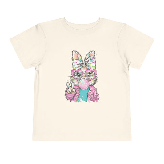 Child wearing a yellow t-shirt with a cartoon character holding pink flowers.