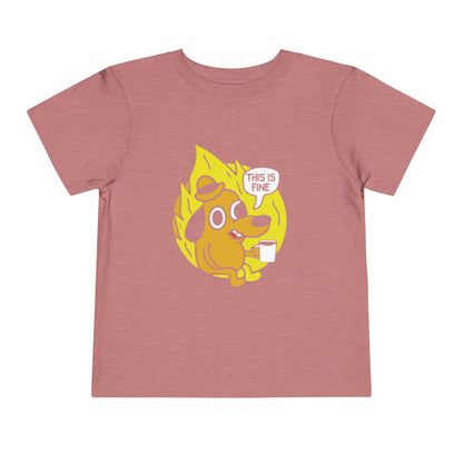 Pink t-shirt with a cartoon dog graphic and 'This is fine' text on a white background