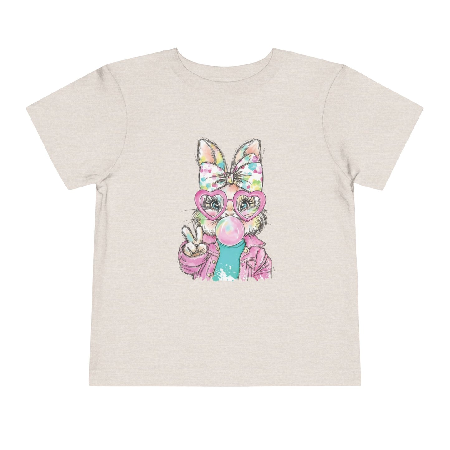 Beige t-shirt with a colorful graphic of a cat wearing glasses and a bow on a white background