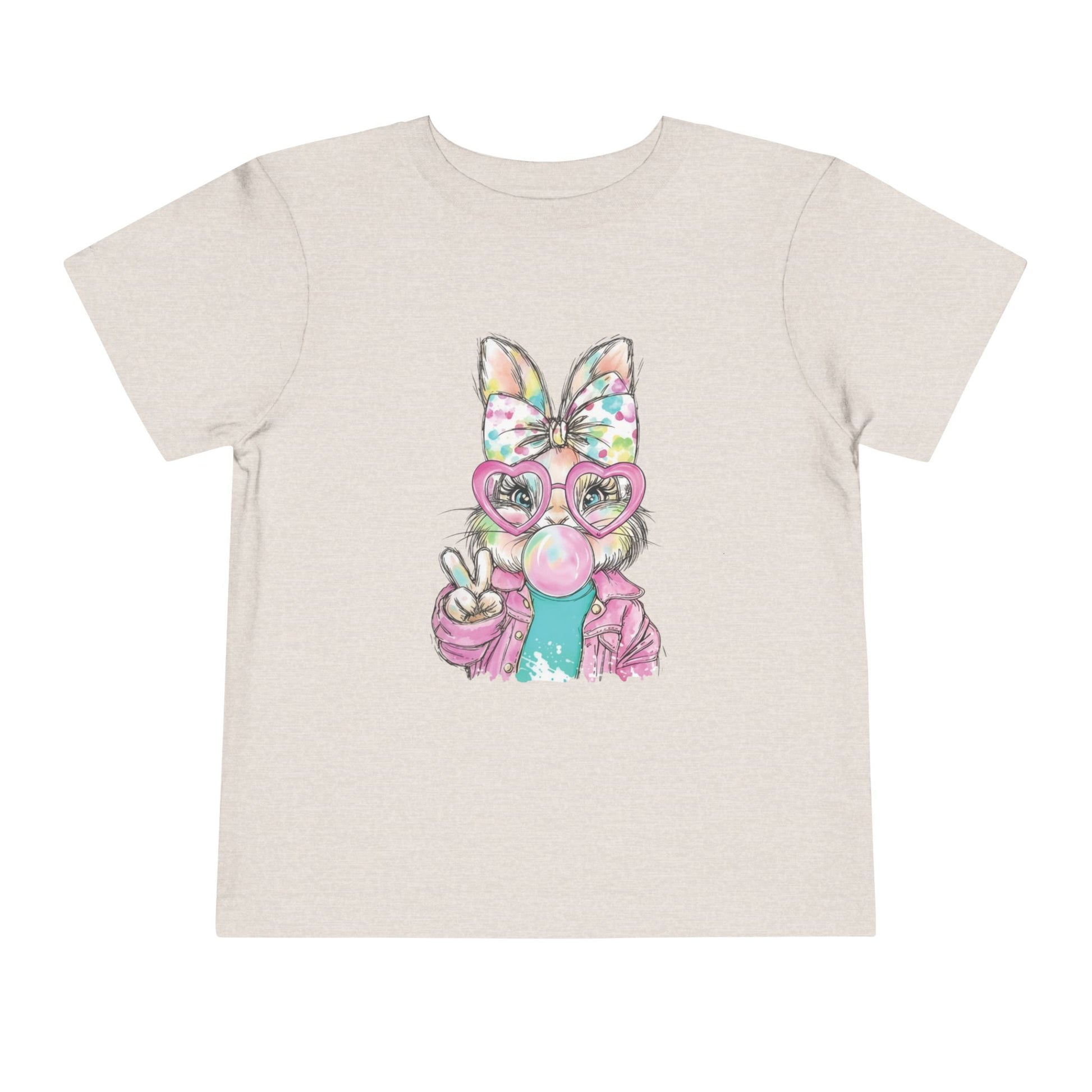 Beige t-shirt with a colorful graphic of a cat wearing glasses and a bow on a white background