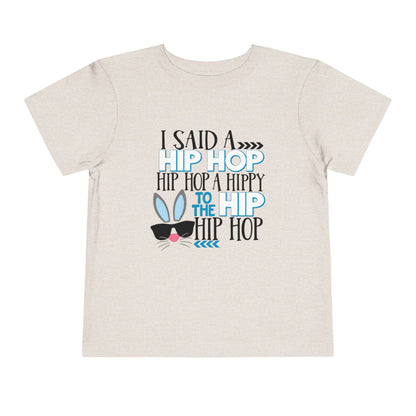 Beige t-shirt with colorful text and graphic on a white background