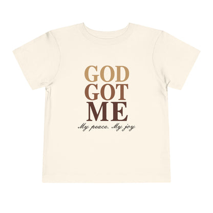 Beige t-shirt with 'God Got Me' text design on a white background