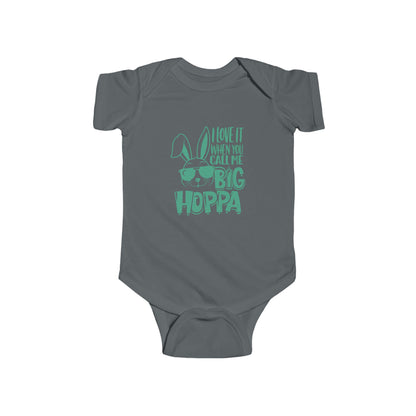 Gray baby onesie with green text and bunny design on a white background