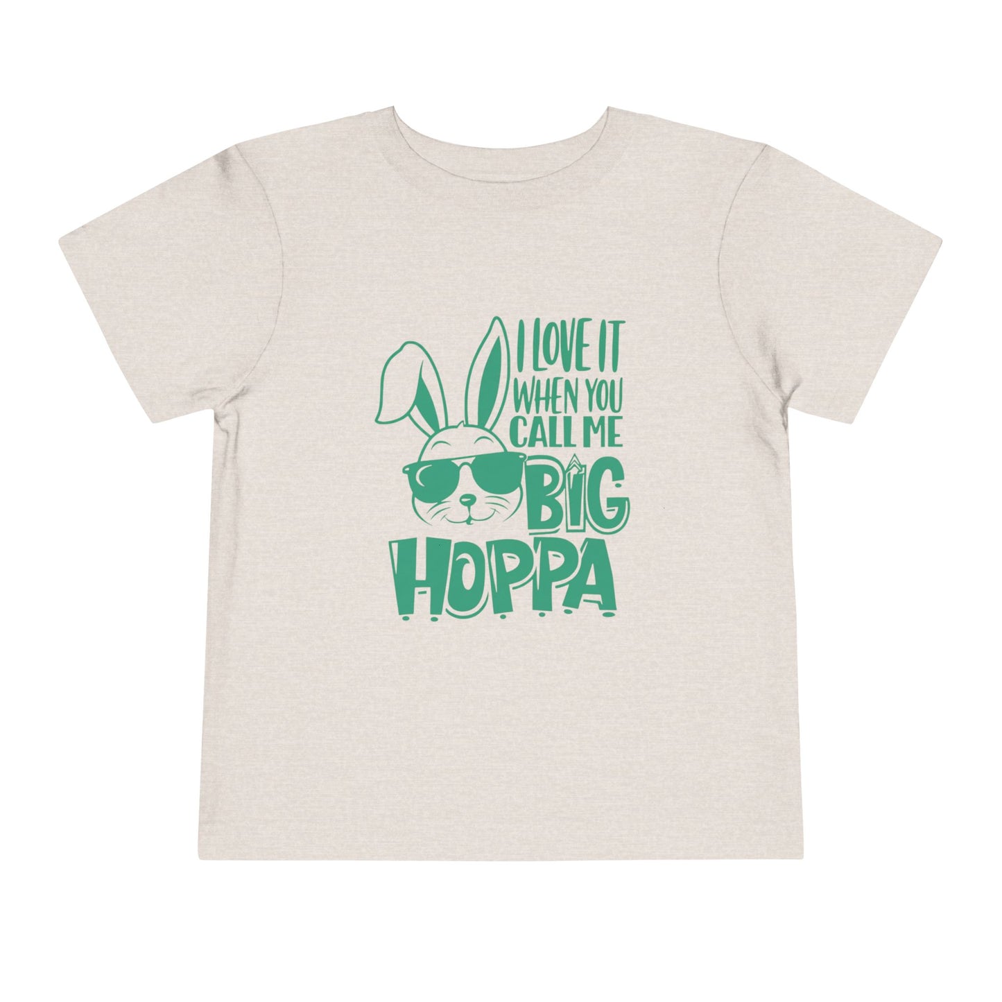 Beige t-shirt with green text and bunny graphic on a white background