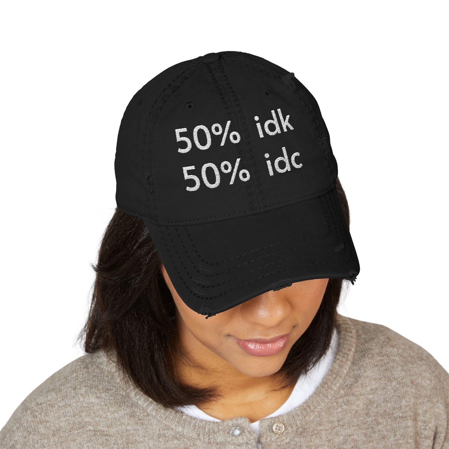 Black cap with text worn by a person on a white background