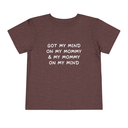 Brown t-shirt with white text on a white background
