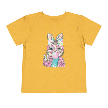 Yellow t-shirt with a cartoon character wearing glasses and a bow on a white background