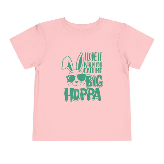 Pink t-shirt with green bunny graphic and text on a white background
