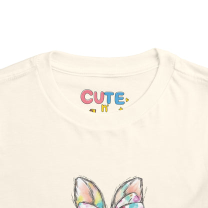 Beige t-shirt with colorful 'CUTE n' text and bunny ears design on a white background