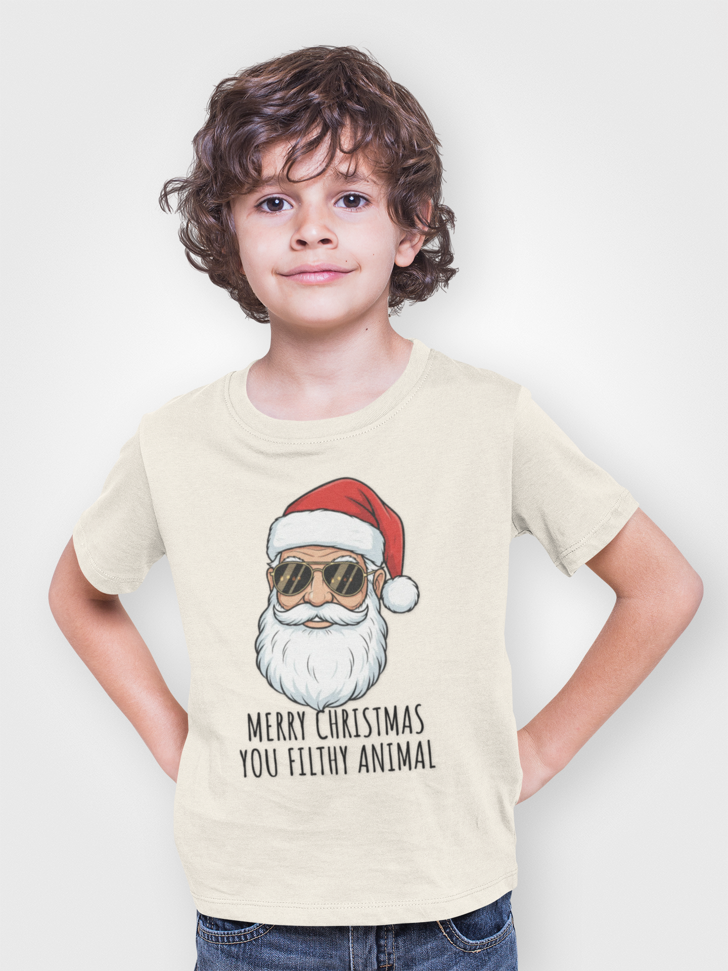 Child wearing a t-shirt with a graphic of Santa Claus and text on a plain background