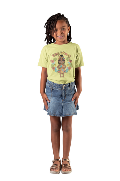 Young girl wearing a yellow t-shirt with a graphic design and a denim skirt on a white background
