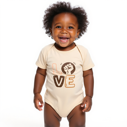 Child wearing a beige onesie with 'LOVE' and a fist graphic on a white background
