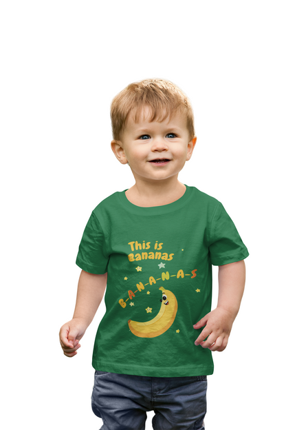 Child wearing a green t-shirt with a banana-themed design on a white background