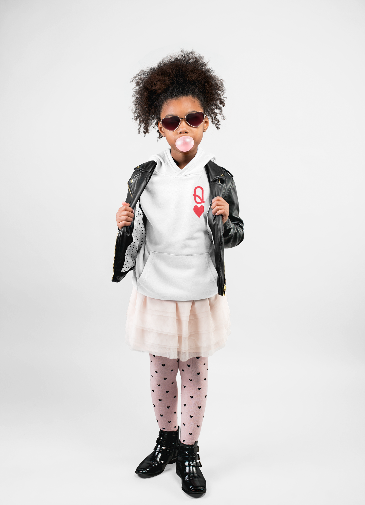 Child wearing a white sweatshirt with a red design, black leather jacket, and pink skirt on a white background