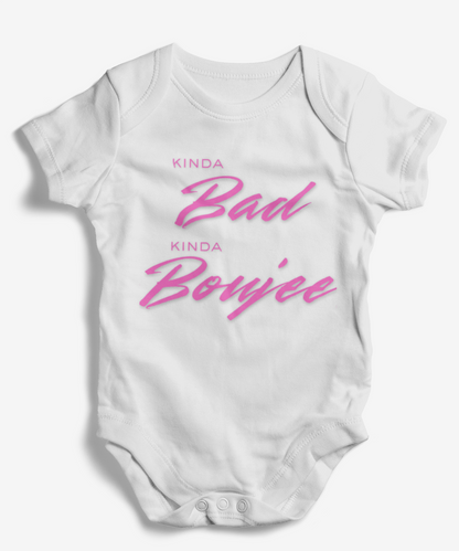 White baby onesie with pink text on a white background