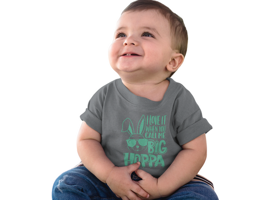 Baby wearing a gray t-shirt with green "Big Hoppa" text on a white background