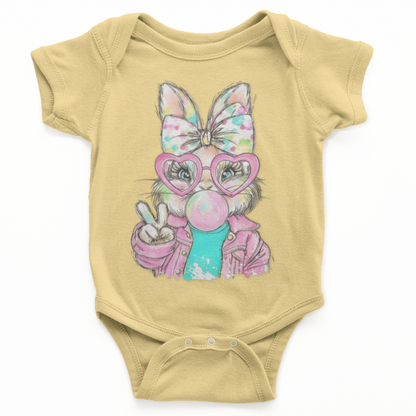 Yellow baby onesie with a cartoon bunny design wearing glasses and holding a bubble gum ball on a white background.