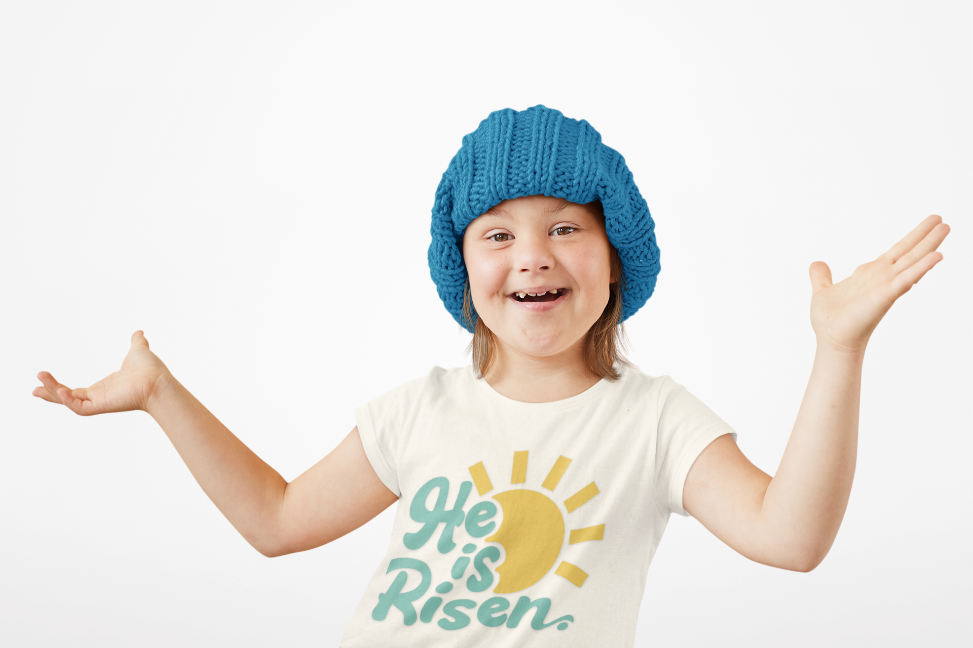 Child wearing a blue knit hat and a 'He is Risen' t-shirt on a white background