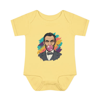 Yellow baby onesie with a colorful graphic of a historical figure on a white background