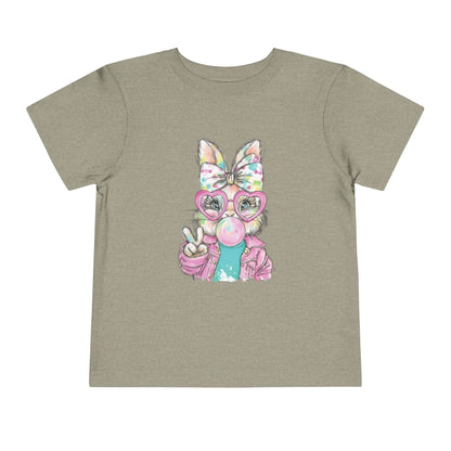 Children's t-shirt with a cartoon character wearing a colorful bow and glasses on a beige background