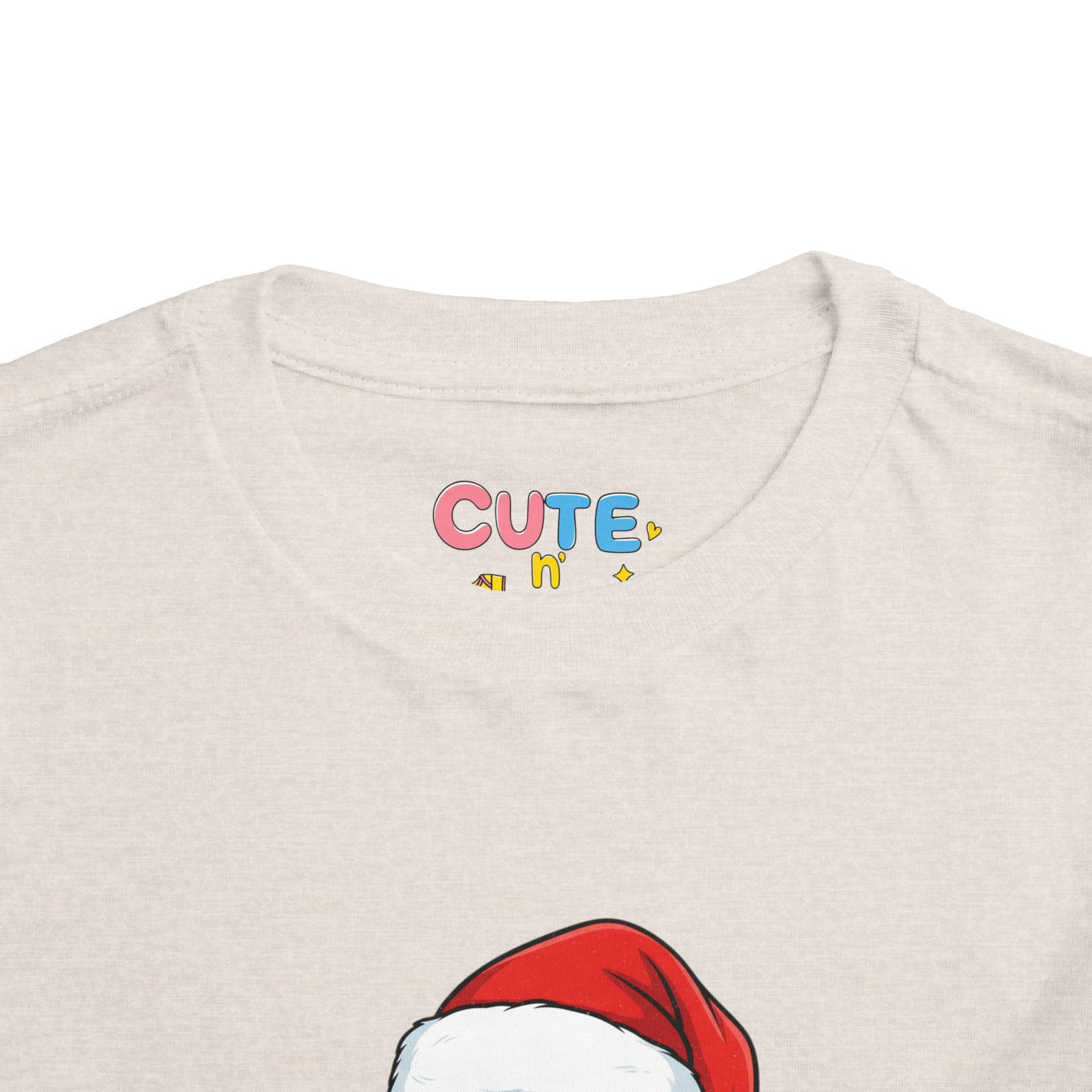 Beige t-shirt with colorful 'CUTE' text and red Santa hat graphic.