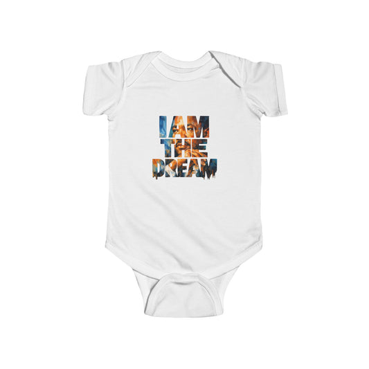Beige baby onesie with 'I AM THE DREAM' text on a white background