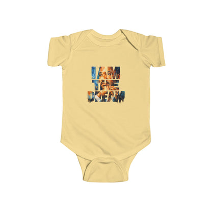 Yellow baby onesie with 'I AM THE DREAM' text on a white background
