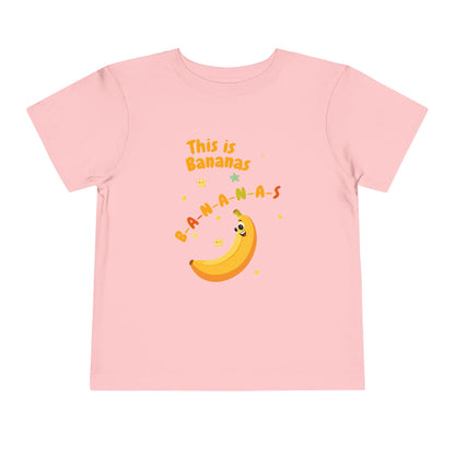 Pink t-shirt with a banana graphic and text on a white background