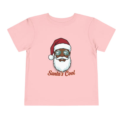 Pink t-shirt with a graphic of a Santa Claus face wearing sunglasses and the text 'Santa's Cool' on a white background.