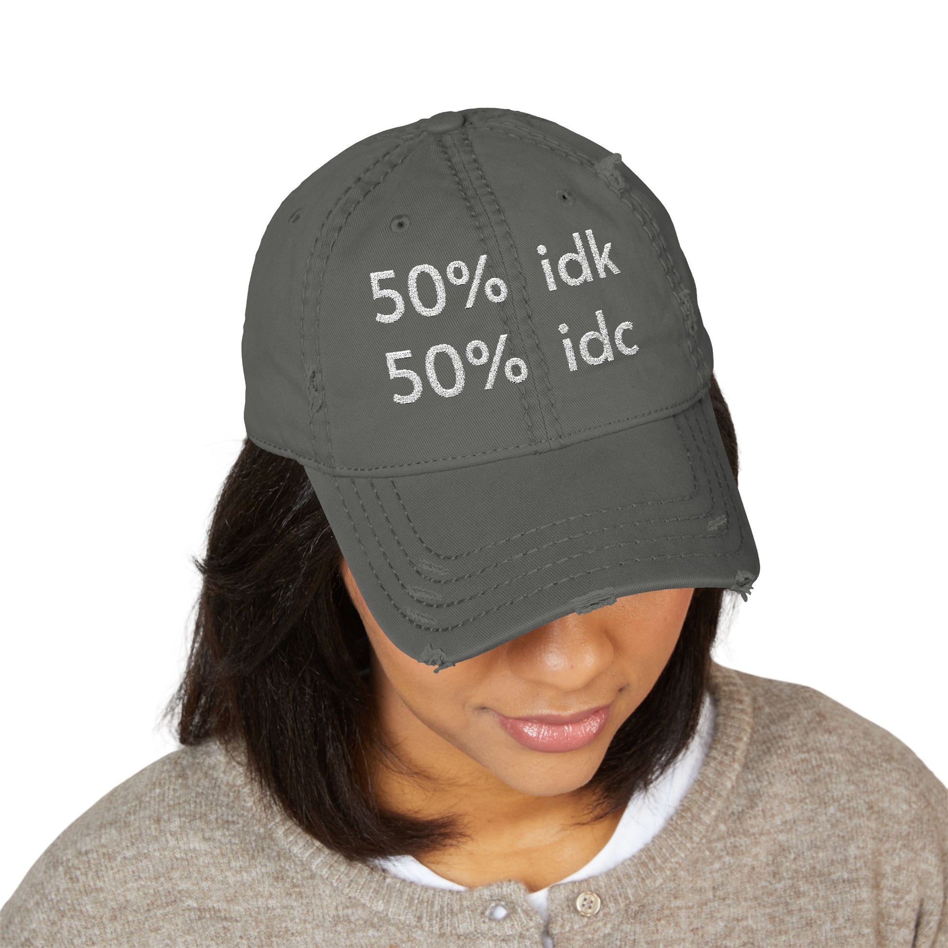 Person wearing a gray cap with '50% idk, 50% idc' text on a white background