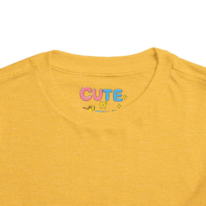 Yellow t-shirt with colorful 'CUTE' text on a white background