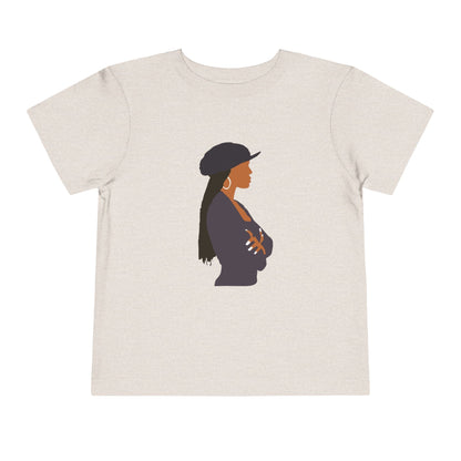 Beige t-shirt with a graphic of a woman wearing a hat on a white background