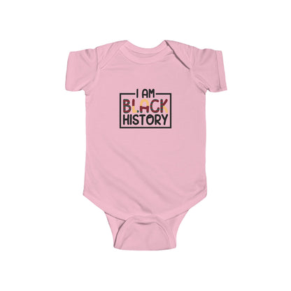 Pink baby onesie with 'I AM BLACK HISTORY' text on a white background