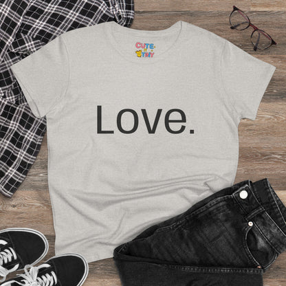 Pink t-shirt with a graphic design of a heart, hands, and flowers on a wooden surface with clothing items.