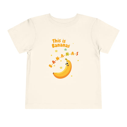 Beige t-shirt with a banana graphic and text on a white background