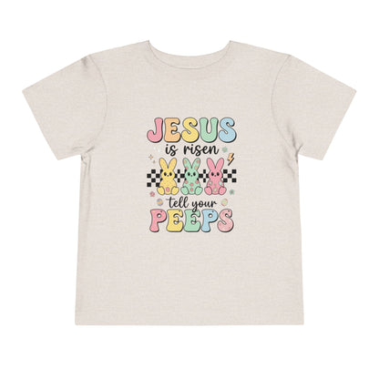 Beige t-shirt with colorful Easter text and bunny graphics on a white background