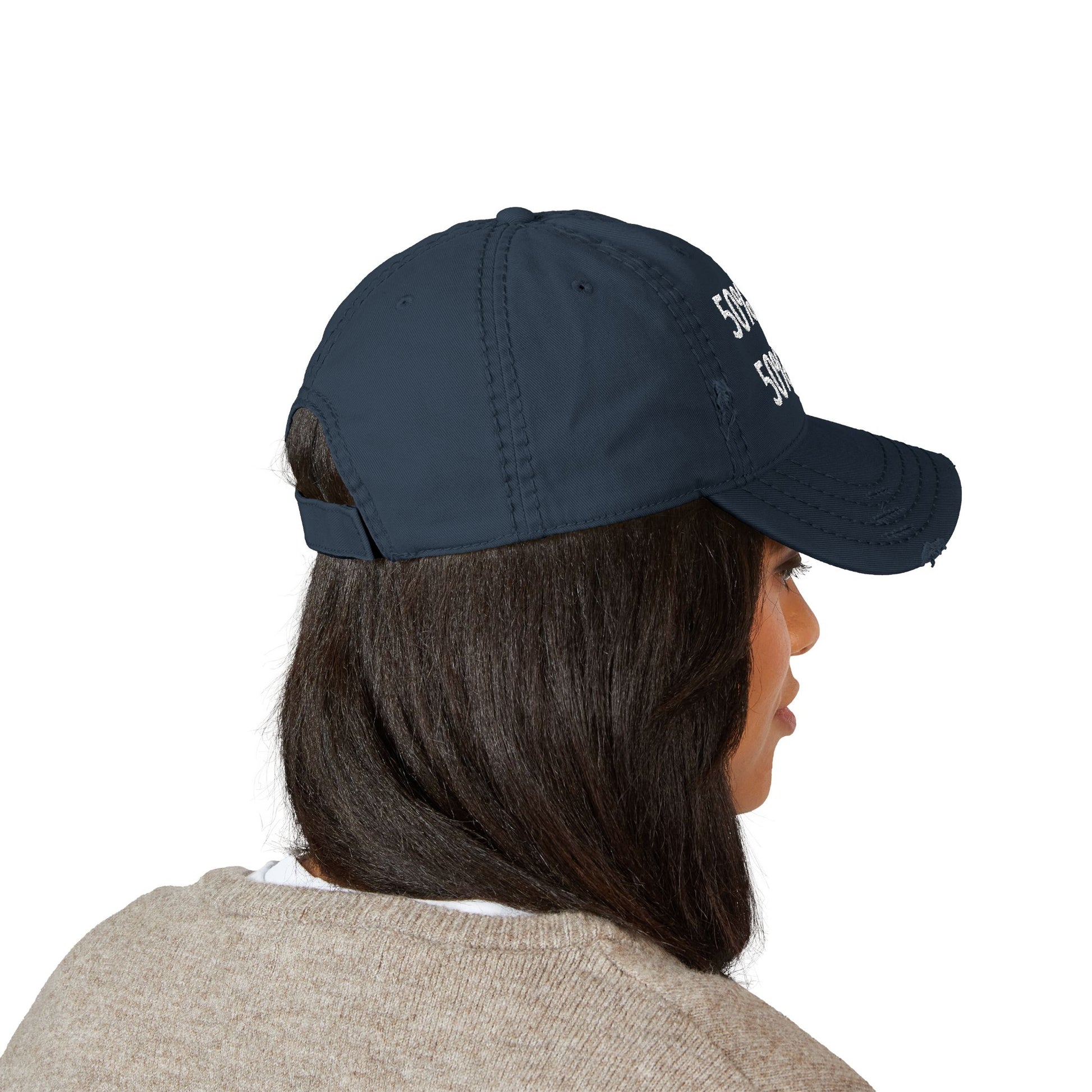 Person wearing a navy blue cap on a white background