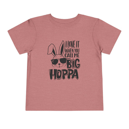 Pink t-shirt with a graphic of a rabbit wearing sunglasses and text on a white background