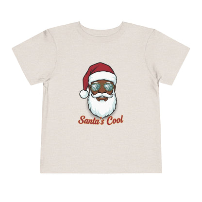 Beige t-shirt with a graphic of a cool Santa Claus wearing sunglasses and 'Santa's Cool' text on a white background.