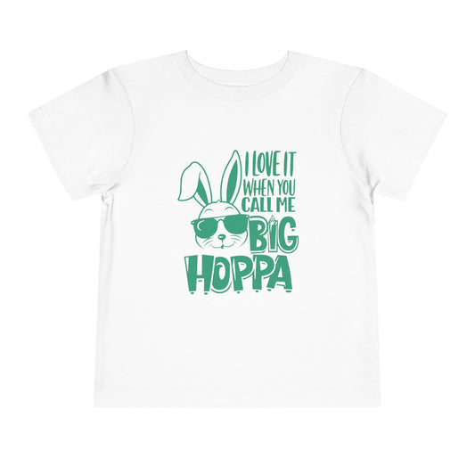 Pink t-shirt with green bunny graphic and text on a white background