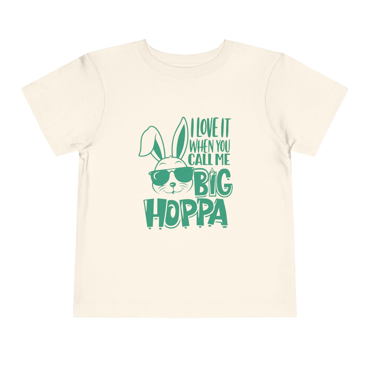 Beige t-shirt with green text and bunny graphic on a white background